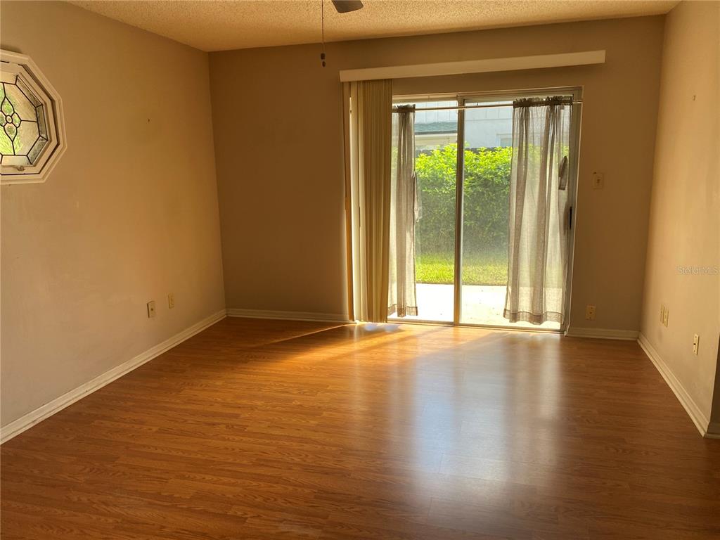 656 Boniview Lane Altamonte Springs, FL 32714 - Photo 14 of 17 a view of an empty room with wooden floor and a window