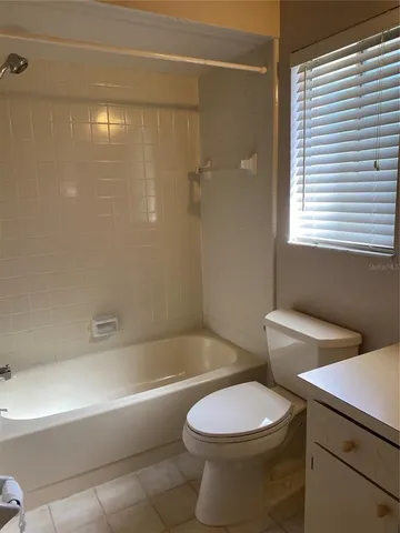 a bathroom with a toilet a sink and bathtub