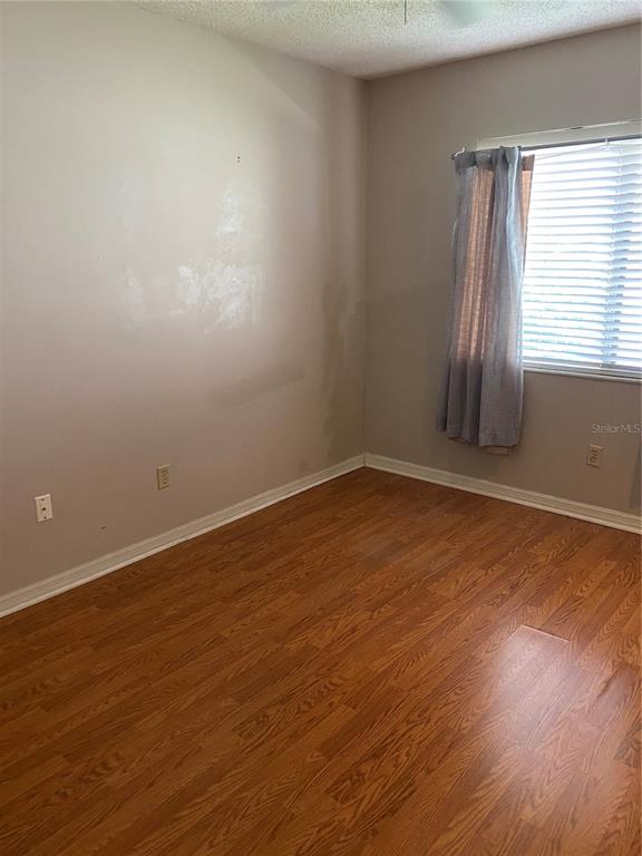 656 Boniview Lane Altamonte Springs, FL 32714 - Photo 6 of 17 an empty room with wooden floor and windows