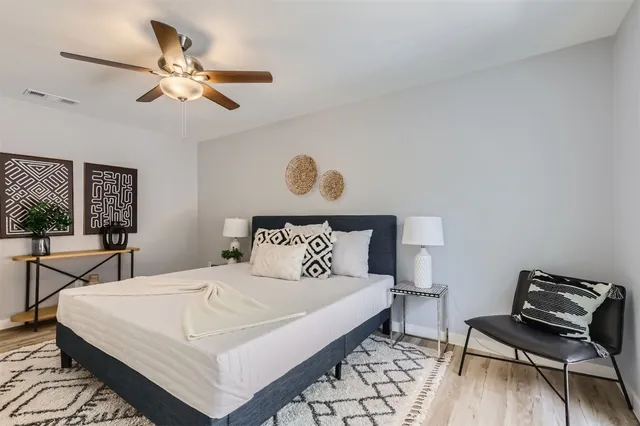 a bedroom with a bed and a chandelier