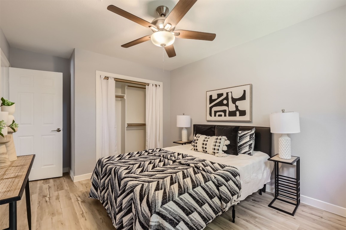 12306 Double Tree Lane Austin, TX 78750 - Photo 20 of 38 a bedroom with a bed and a chandelier