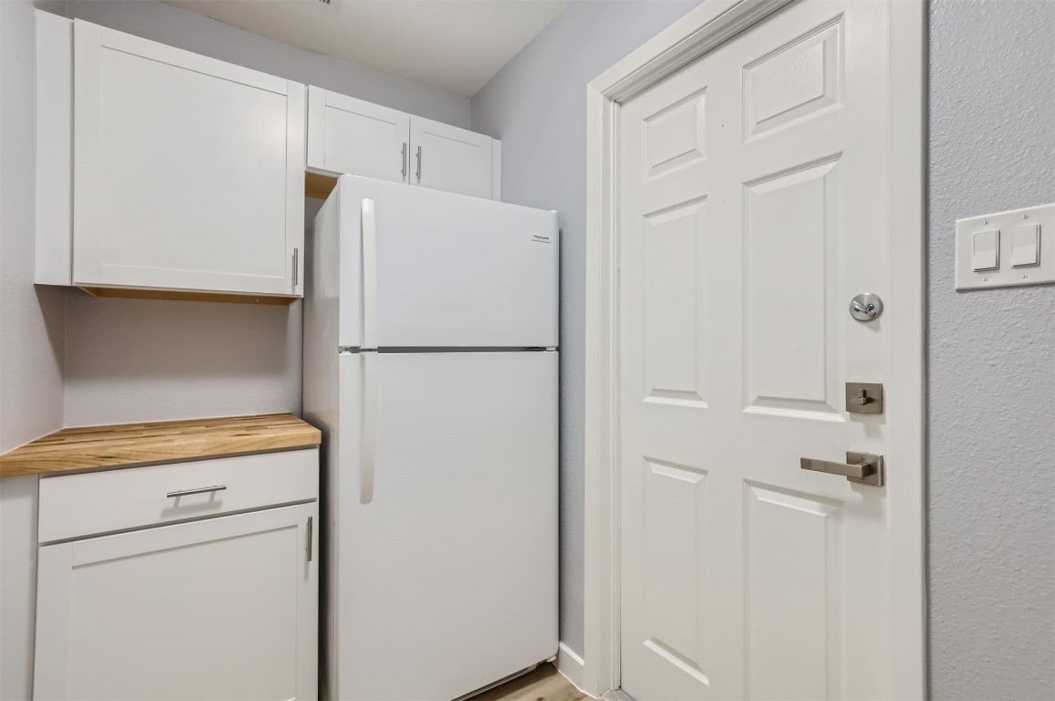 12306 Double Tree Lane Austin, TX 78750 - Photo 23 of 38 a white refrigerator freezer and a stove sitting inside of a kitchen