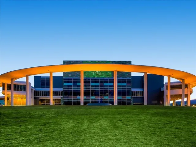 a front view of a building with trees