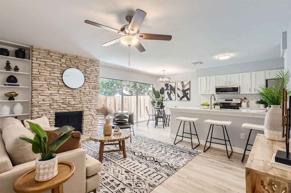 12306 Double Tree Lane Austin, TX 78750 - Photo 3 of 38 a living room with furniture a fireplace and a floor to ceiling window