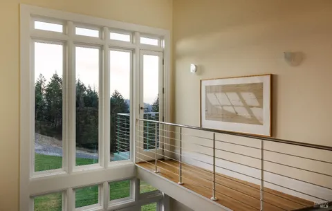 a bedroom with two beds and a large window