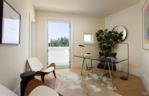 a view of a white house with a yard