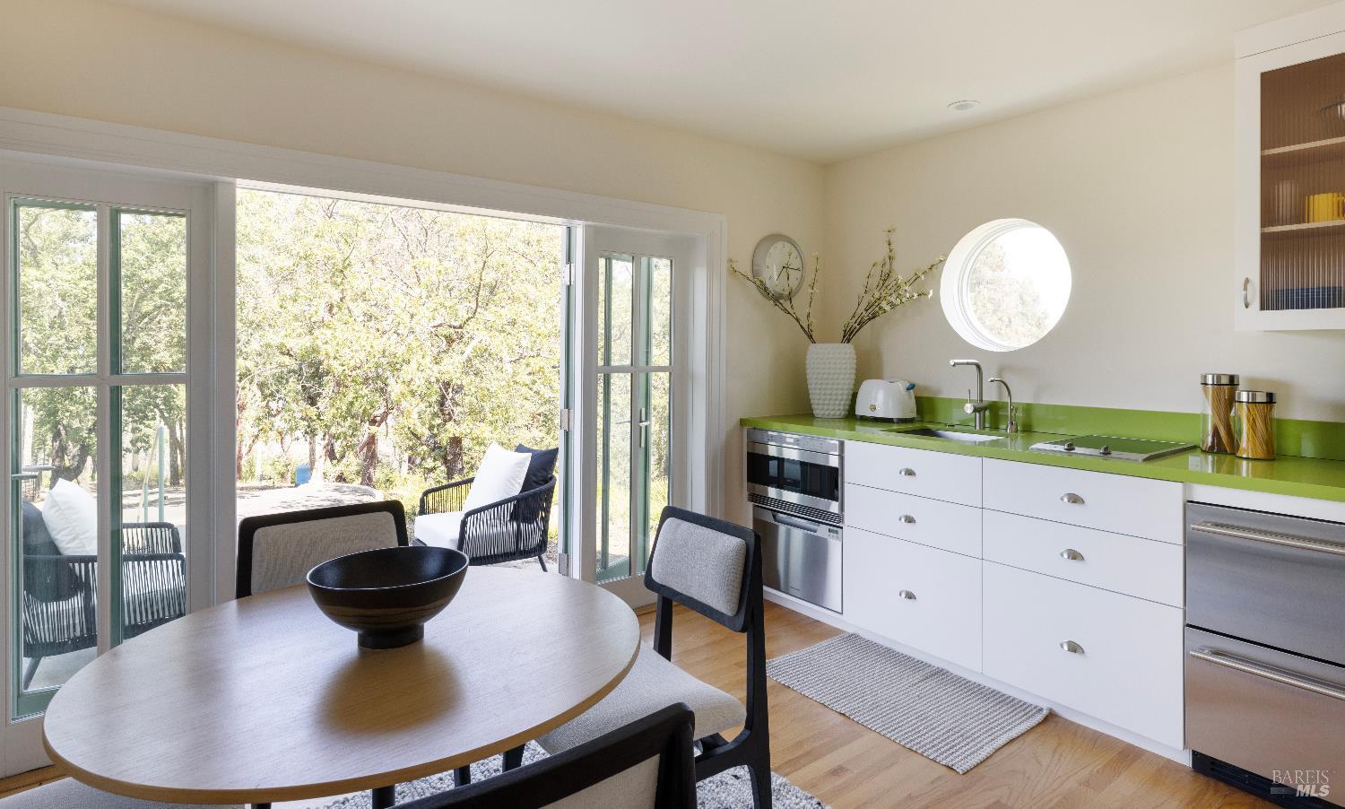 3000 Mt Veeder Road Napa, CA 94558 - Photo 55 of 85 a view of a dining room with furniture a chandelier and wooden floor