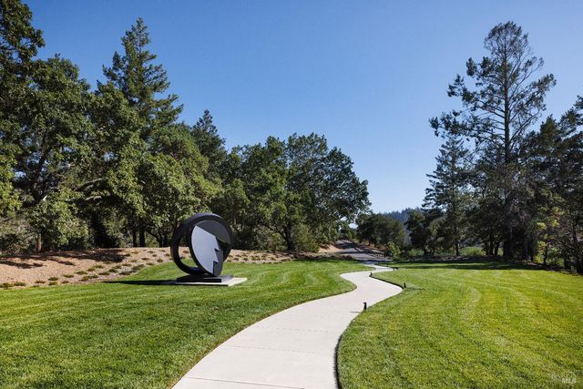 a view of a white house with a yard