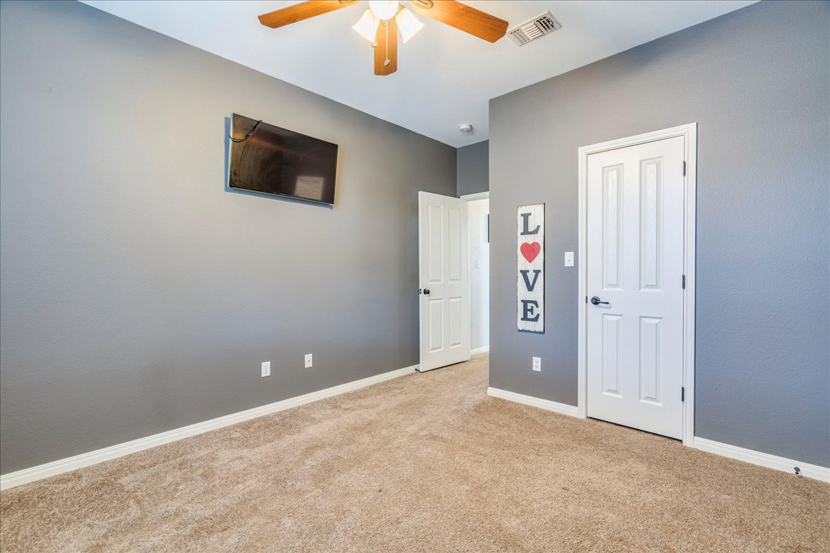 11 Rhapsody Lane Wimberley, TX 78676 - Photo 21 of 35 an empty room with closet and a chandelier fan