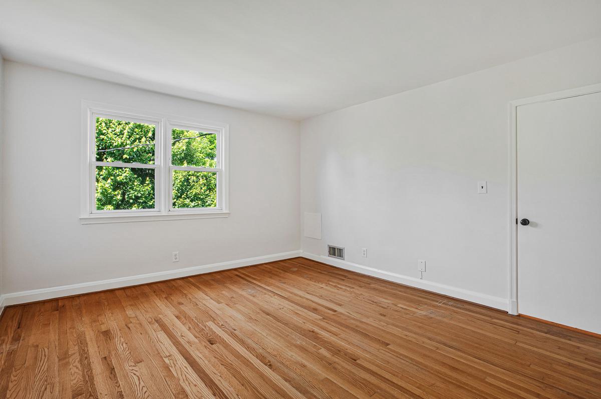 1016 Winsford Road Towson, MD 21204 - Photo 20 of 42 a view of an empty room with wooden floor and a window