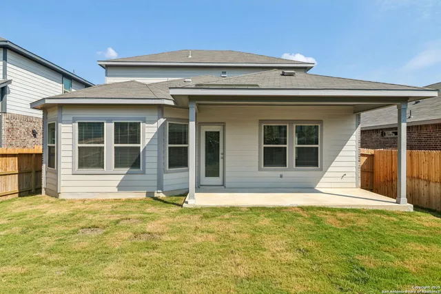 a view of a house with a backyard