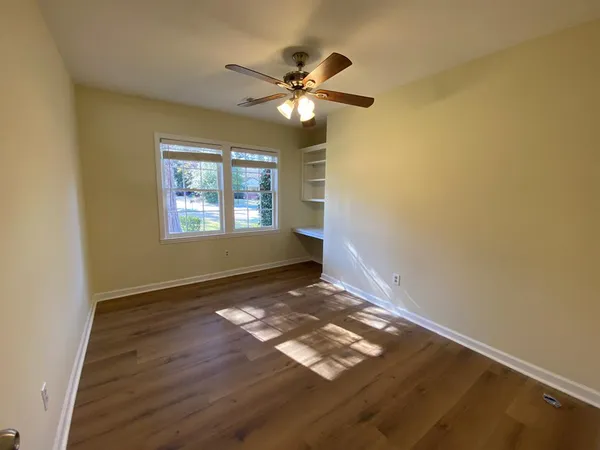 a view of walk in closet with empty racks
