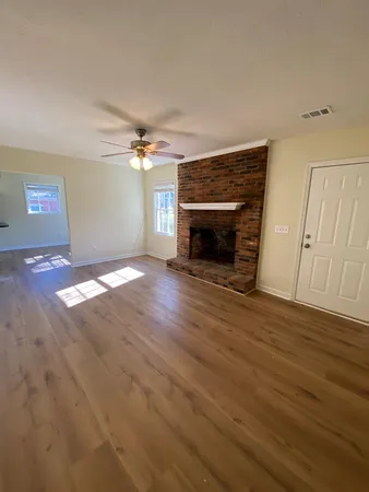 a view of a livingroom with a fireplace and a ceiling fan