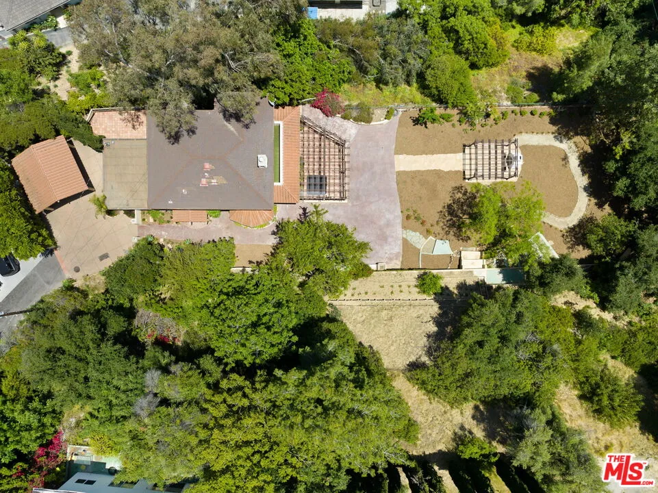 an aerial view of a house with a yard