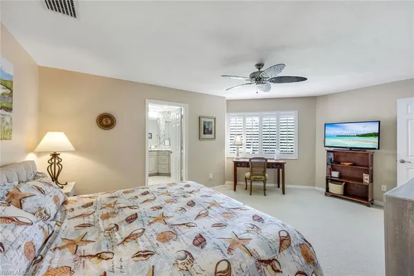 a bedroom with a bed and a table with chair