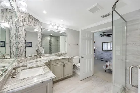 a bathroom with a sink double vanity and a toilet