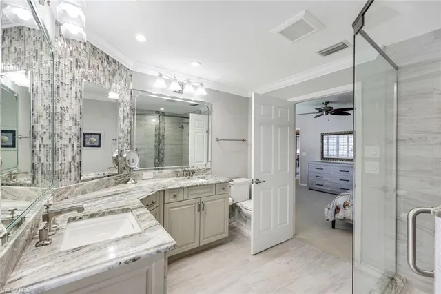 a bathroom with a sink double vanity and a toilet