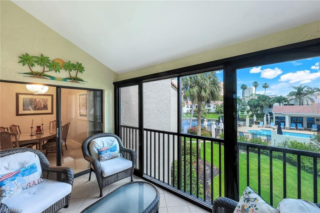 6555 Valen Way, Unit G201 Naples, FL 34108 - Photo 21 of 26 a living room with furniture and a floor to ceiling window
