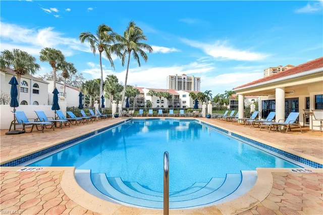 a swimming pool with outdoor seating and yard