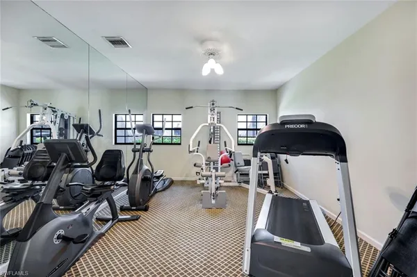 a view of a livingroom with furniture and gym equipment