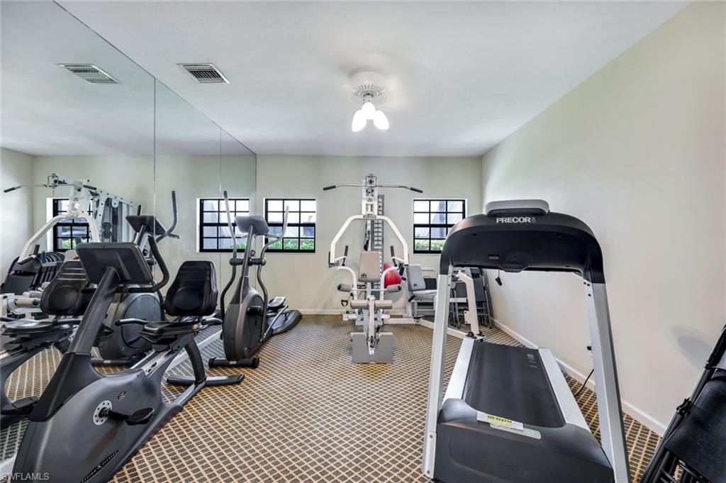 6555 Valen Way, Unit G201 Naples, FL 34108 - Photo 23 of 26 a view of a livingroom with furniture and gym equipment