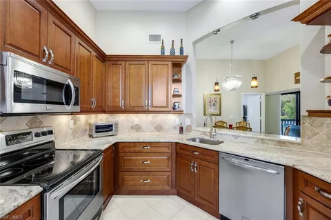 a kitchen with a sink stove and microwave