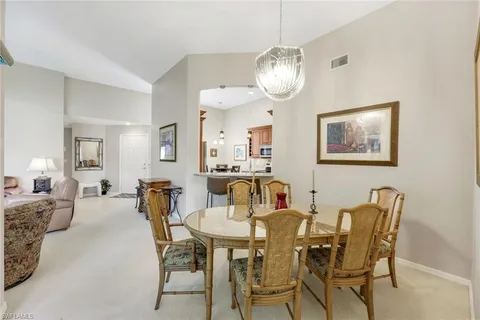 a view of a dining room with furniture and chandelier