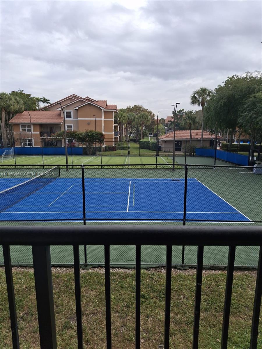 8801 Wiles Road, Unit 208 Coral Springs, FL 33067 - Photo 3 of 11 a view of a tennis ground with large trees