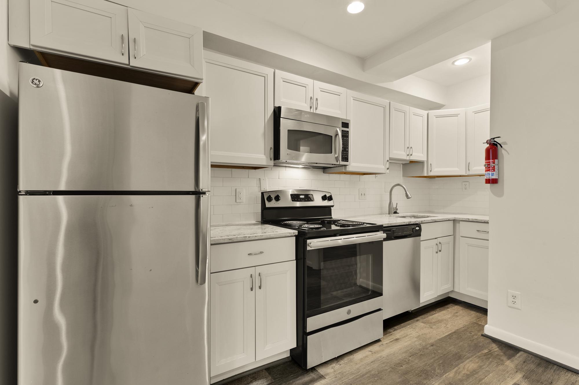 619 Independence Avenue Southeast Washington, DC 20003 - Photo 32 of 38 a kitchen with stainless steel appliances white cabinets white stove a sink and a refrigerator
