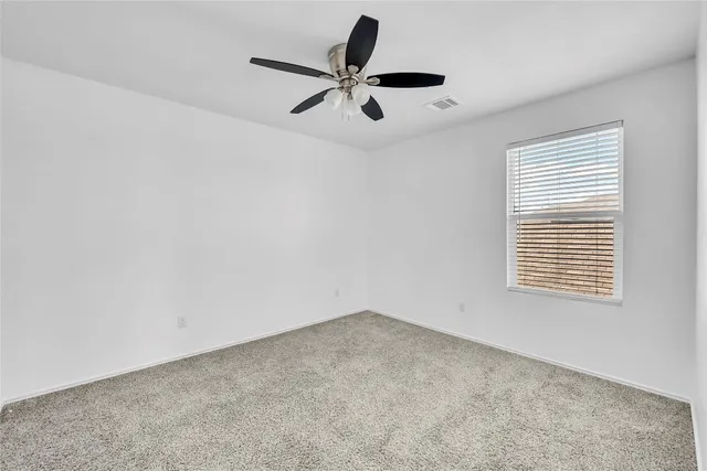 a view of room with a ceiling fan and window