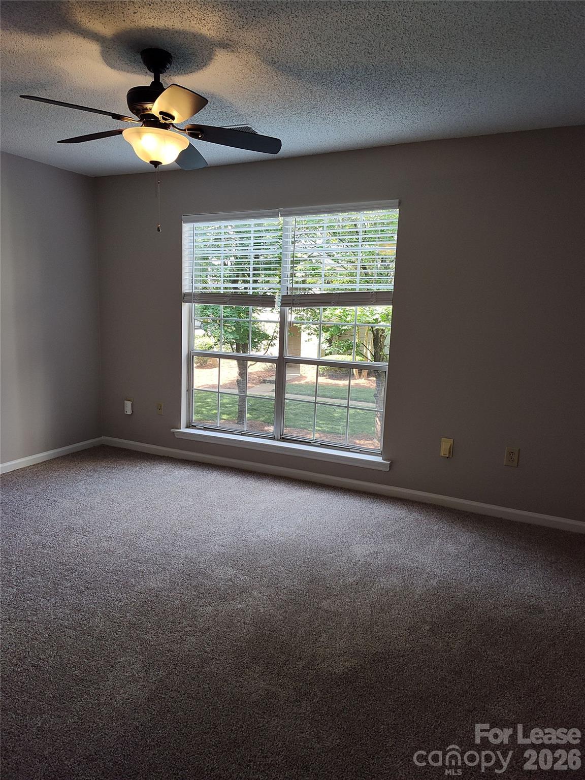 5001 Sharon Road, Unit K Charlotte, NC 28210 - Photo 19 of 24 a view of an empty room with a window