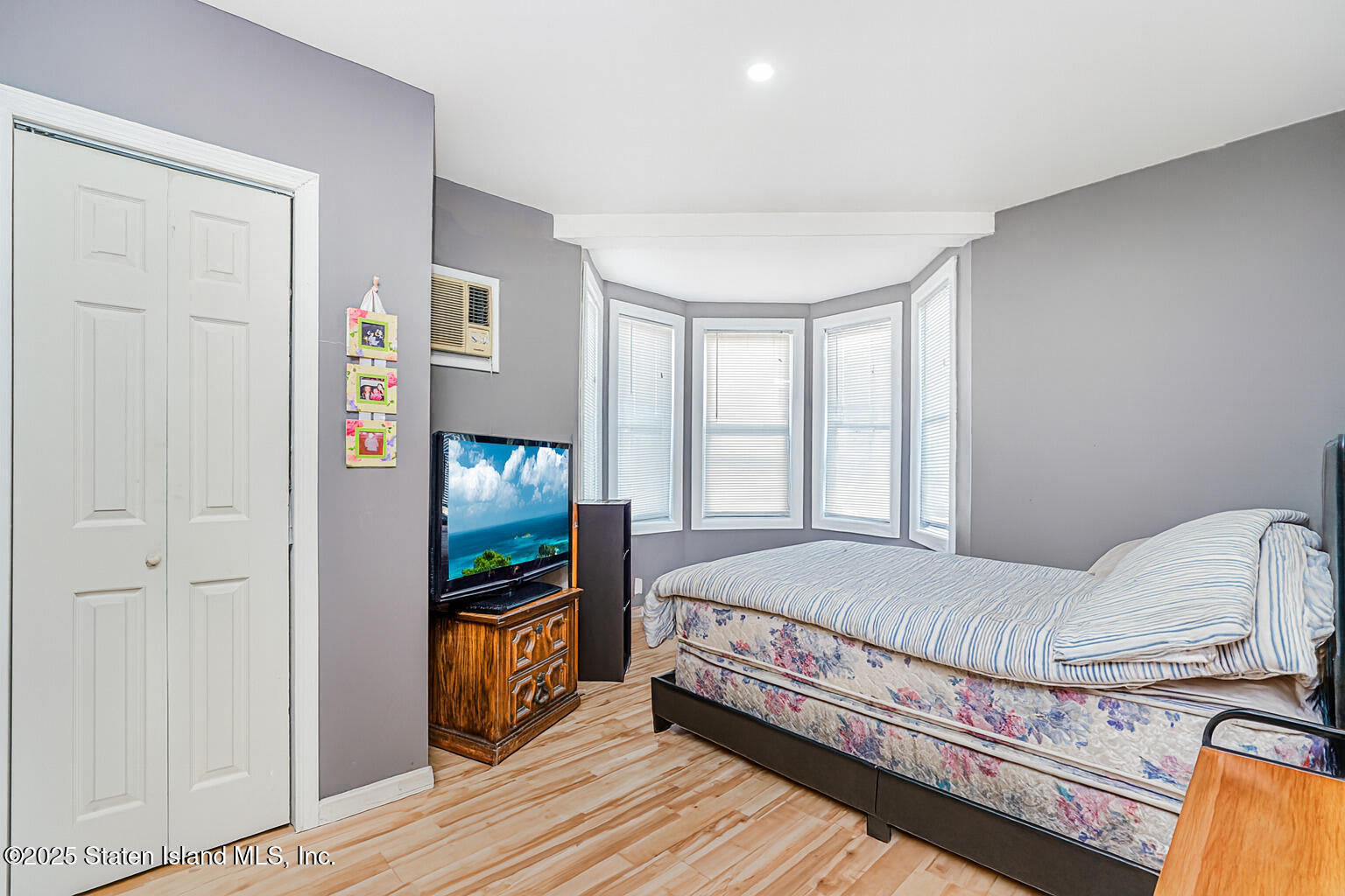 4062 Amboy Road Staten Island, NY 10308 - Photo 11 of 21 a bedroom with a bed and a flat tv screen