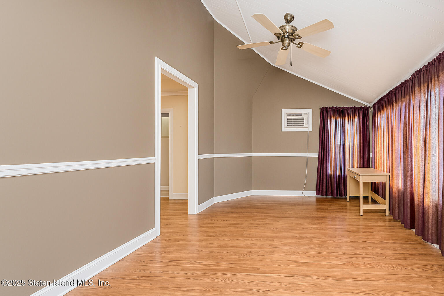 4062 Amboy Road Staten Island, NY 10308 - Photo 15 of 21 a view of a livingroom with wooden floor and a ceiling fan
