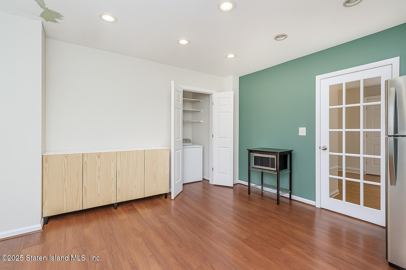 4062 Amboy Road Staten Island, NY 10308 - Photo 17 of 21 an empty room with wooden floor and windows
