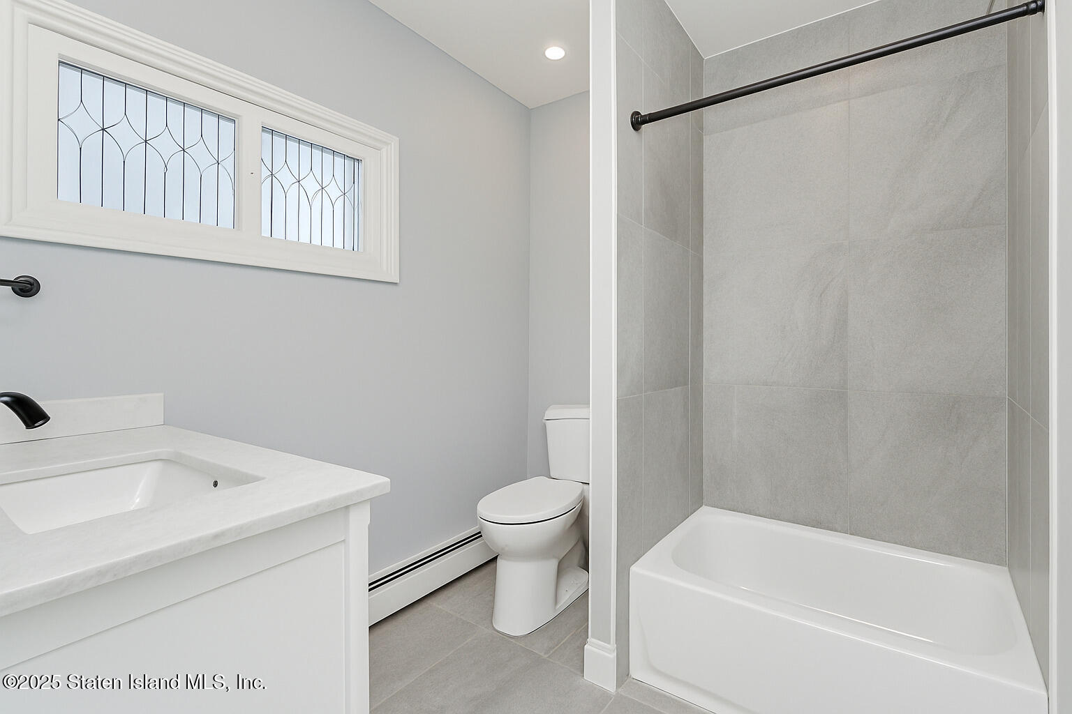 4062 Amboy Road Staten Island, NY 10308 - Photo 20 of 21 a white bath tub sitting next to a white toilet and a sink
