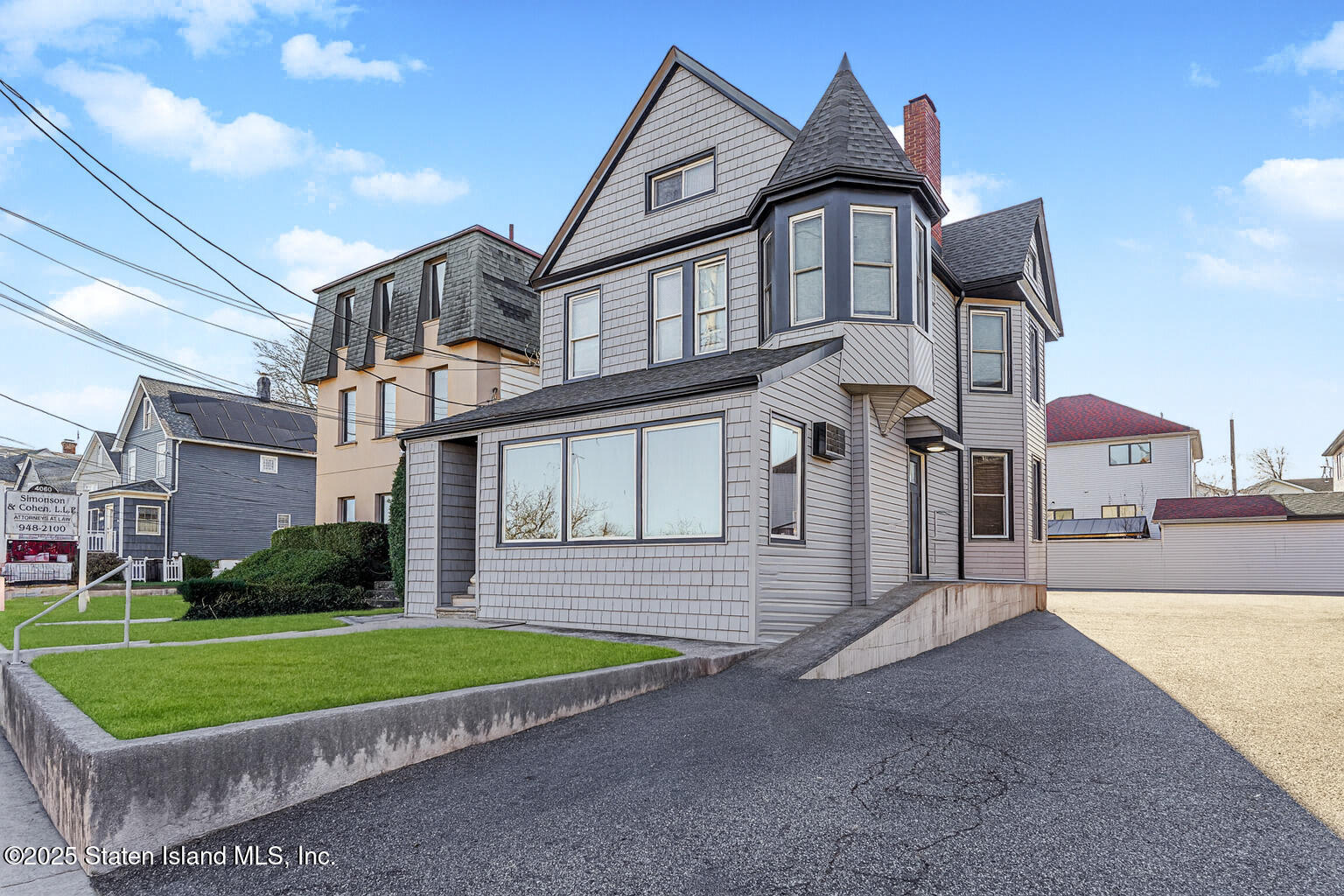 4062 Amboy Road Staten Island, NY 10308 - Photo 4 of 21 a front view of a house with a yard and garage