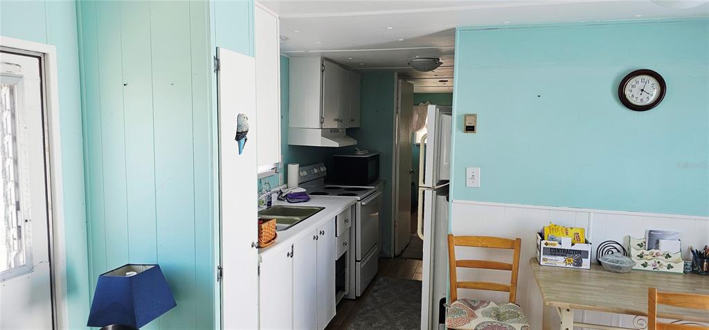 10315 Cortez Road West, Unit 242 Bradenton, FL 34210 - Photo 7 of 18 a kitchen with a refrigerator and a stove top oven