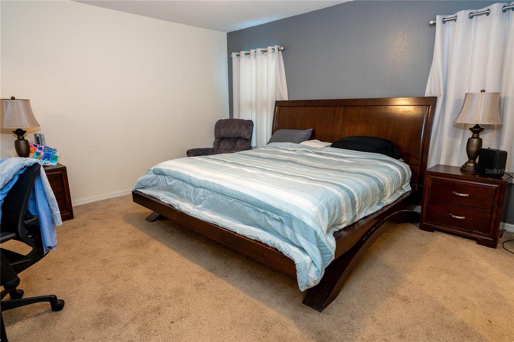 4563 Orchard Grove Road St. Cloud, FL 34772 - Photo 19 of 51 a bedroom with a bed and a closet