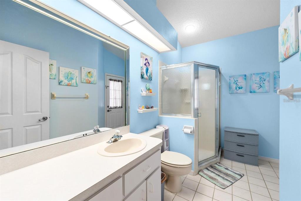 10228 Yellow Pine Way Hudson, FL 34667 - Photo 15 of 22 a bathroom with a sink a toilet and shower