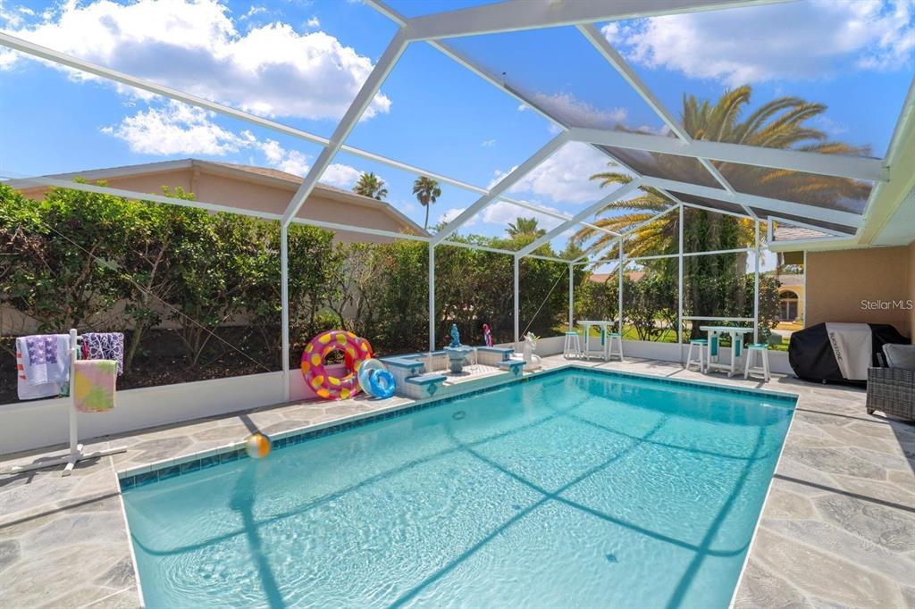 10228 Yellow Pine Way Hudson, FL 34667 - Photo 2 of 22 a view of a patio with a table and chairs