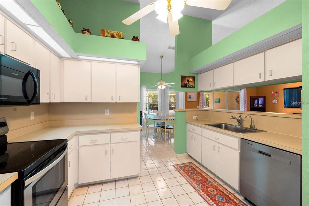10228 Yellow Pine Way Hudson, FL 34667 - Photo 7 of 22 a kitchen with a sink window and cabinets
