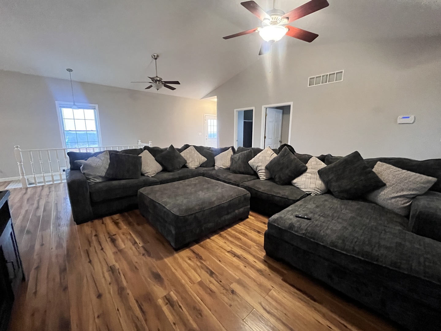 5488 Tick Ridge Road Grand Chain, IL 62941 - Photo 17 of 55 a living room with couches a fireplace and a chandelier