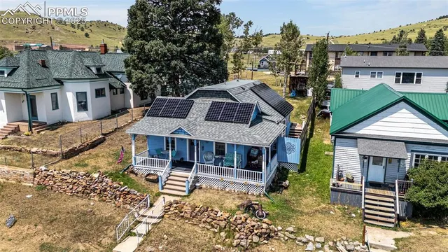 an aerial view of a house with yard swimming pool and outdoor seating