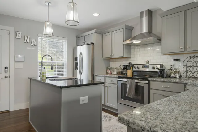a kitchen with stainless steel appliances granite countertop a sink and cabinets
