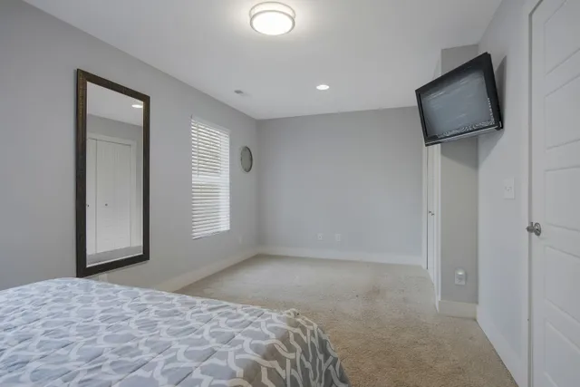 a bedroom with furniture and a window