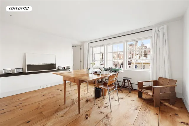a dining room with furniture and a potted plant