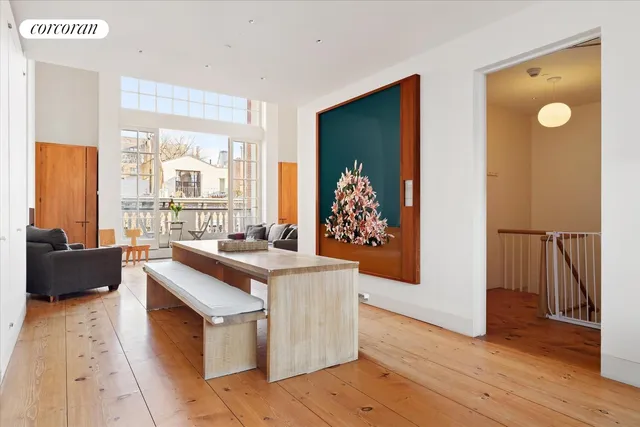 a view of a dining room with furniture and a window