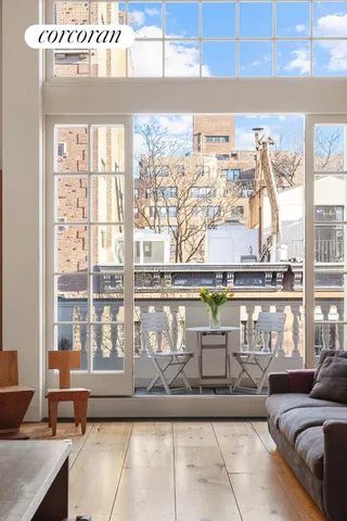 a view of living room kitchen with furniture and wooden floor