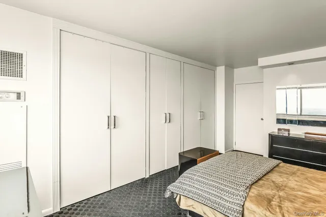 a bedroom with a bed and a walk in closet