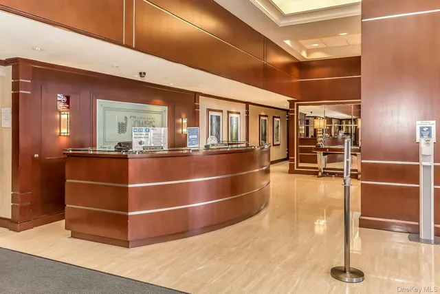 a view of a hallway with wooden floor and stairs